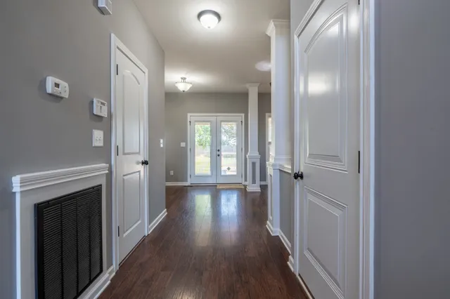 a view of a hallway with wooden floor