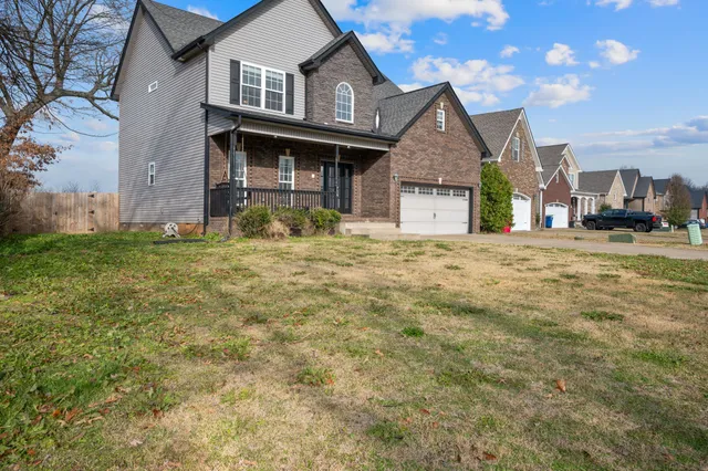 a front view of a house with a garden