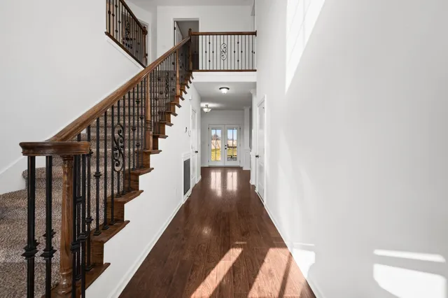 a view of entryway and hall with wooden floor