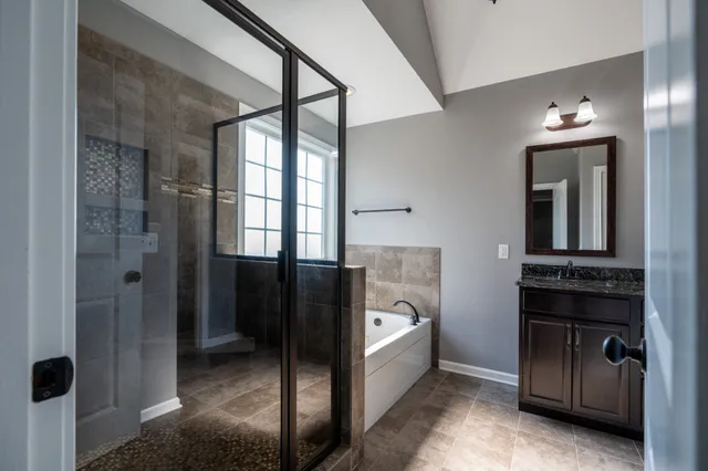 a view of a hallway and a livingroom with furniture
