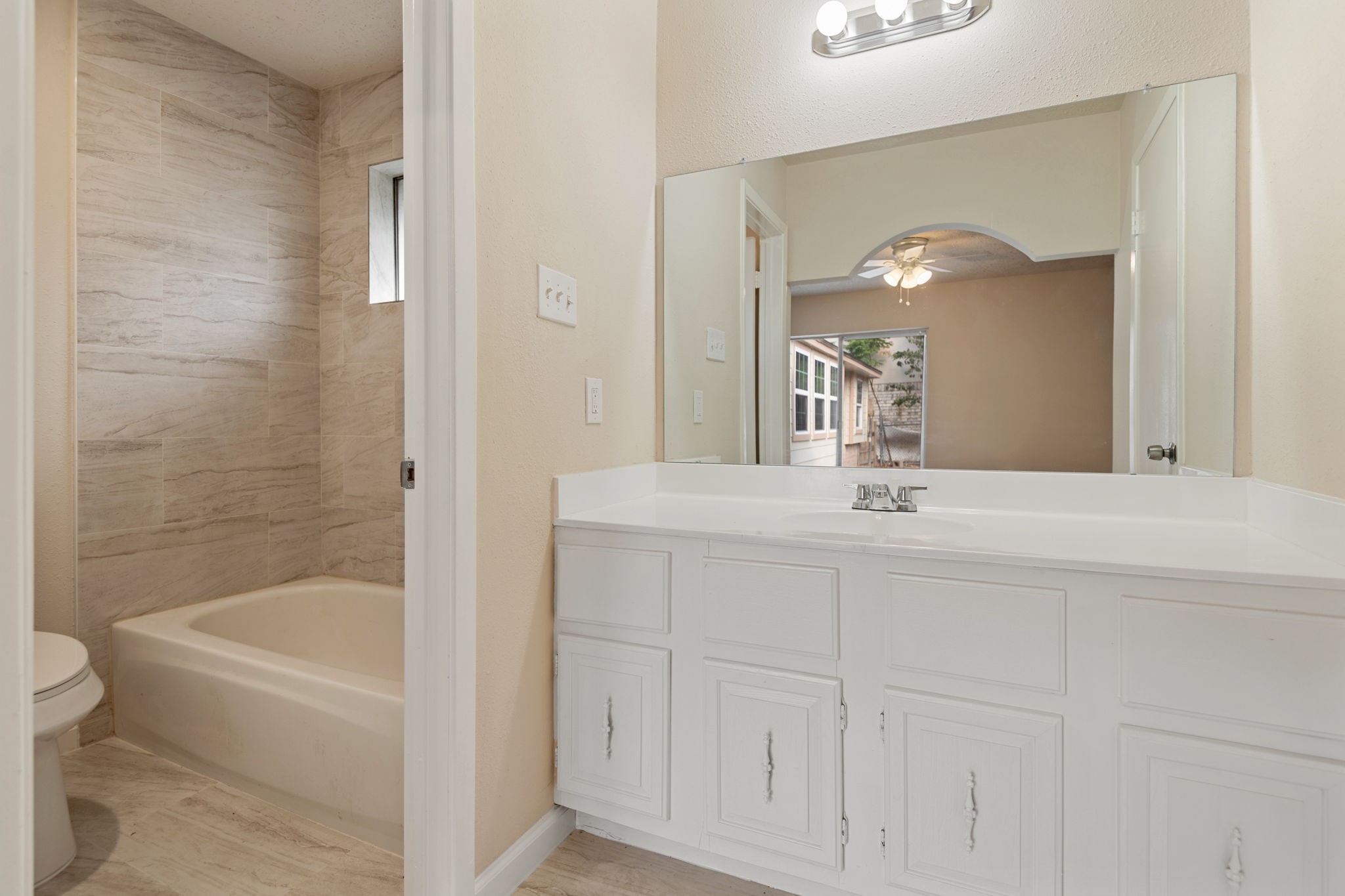 13315 Cologne Drive Houston, TX 77065 - Photo 13 of 15 a bathroom with a bathtub a sink a toilet and a mirror