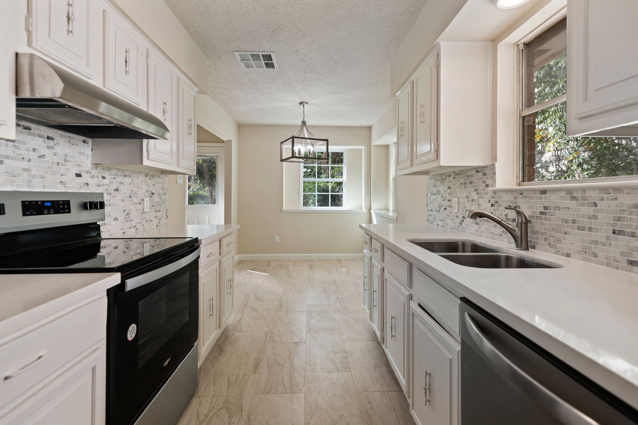 13315 Cologne Drive Houston, TX 77065 - Photo 4 of 15 a kitchen with a sink stove top oven and cabinets