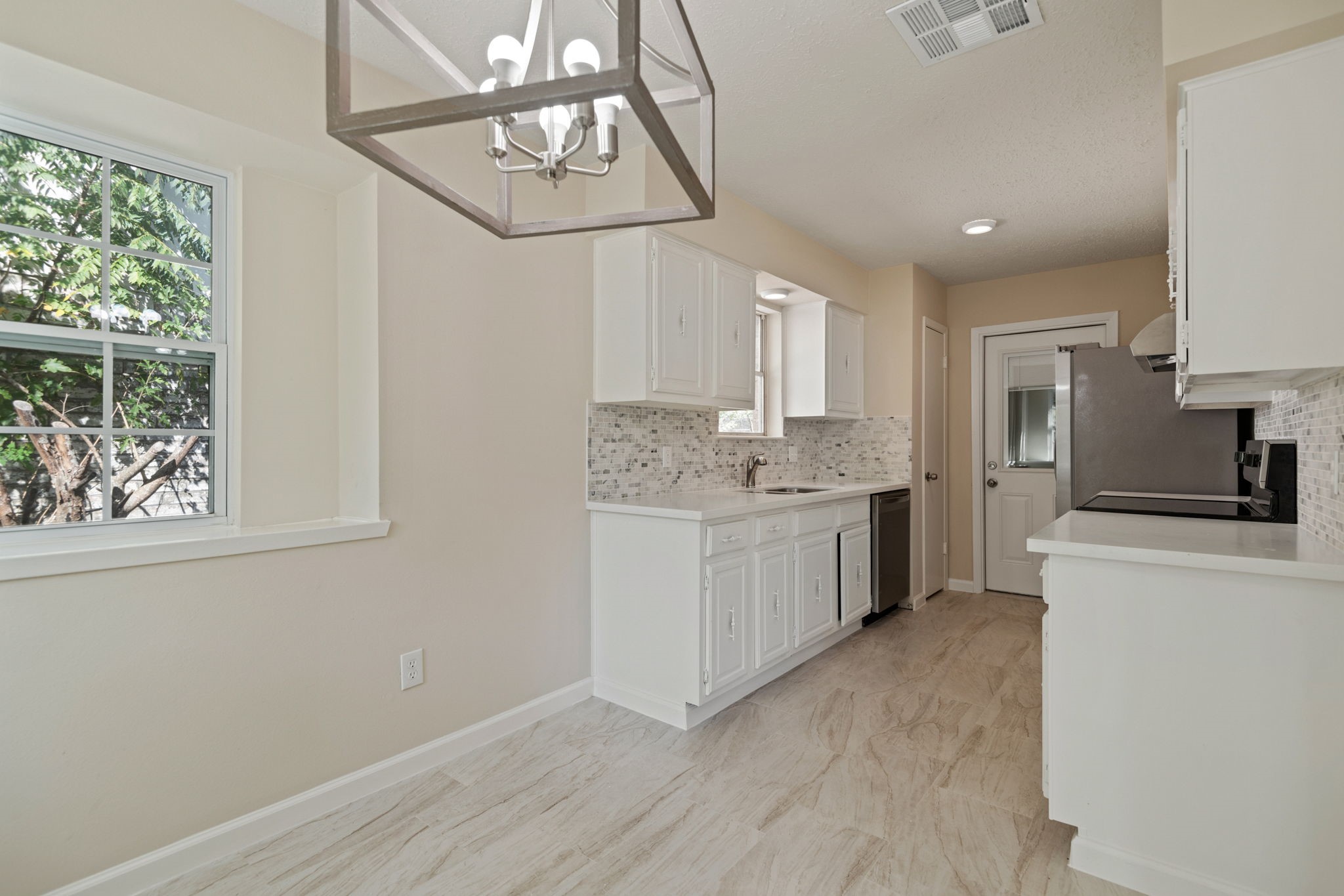 13315 Cologne Drive Houston, TX 77065 - Photo 5 of 15 a kitchen with a white cabinets stove and refrigerator