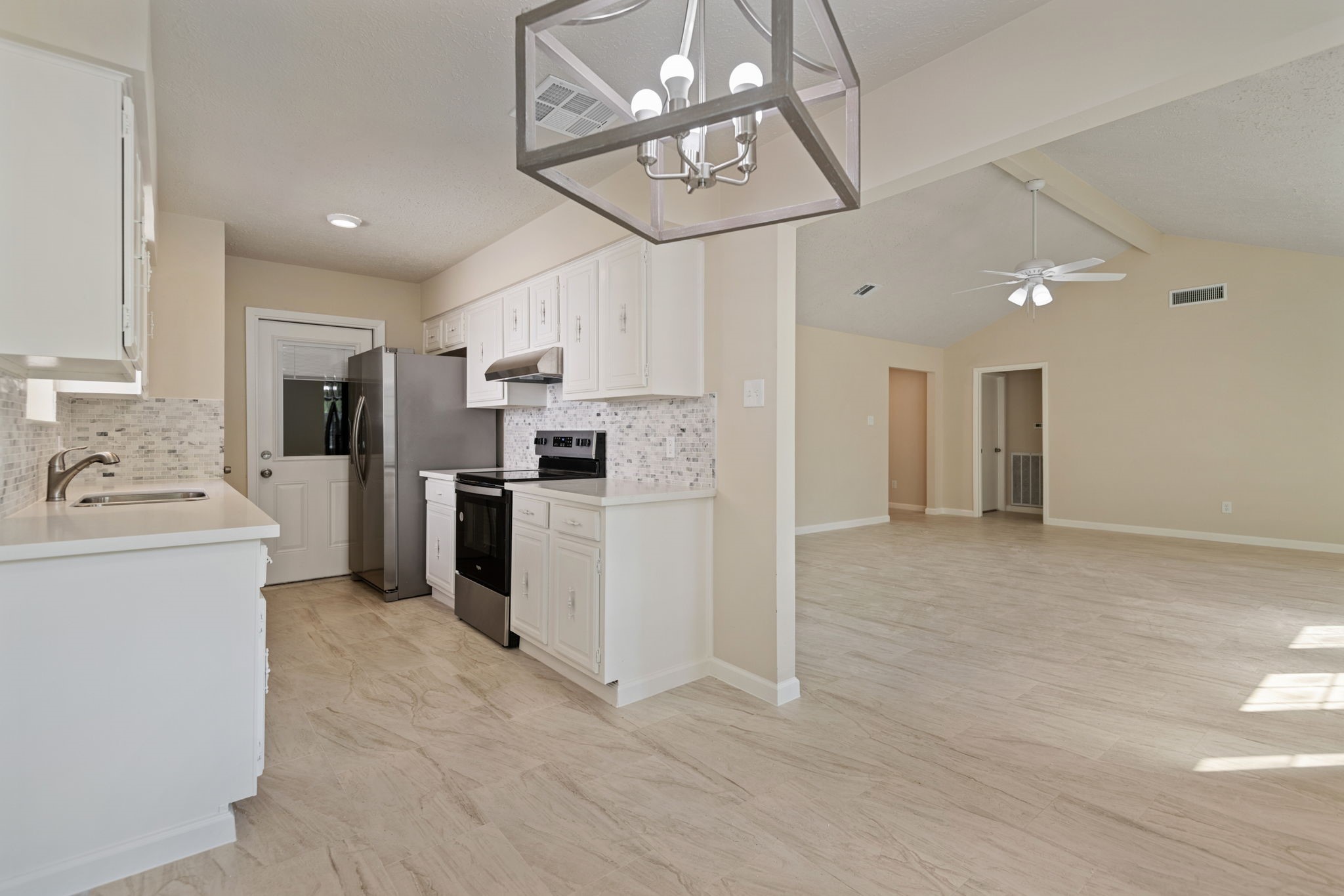13315 Cologne Drive Houston, TX 77065 - Photo 6 of 15 a kitchen with refrigerator cabinets and a sink
