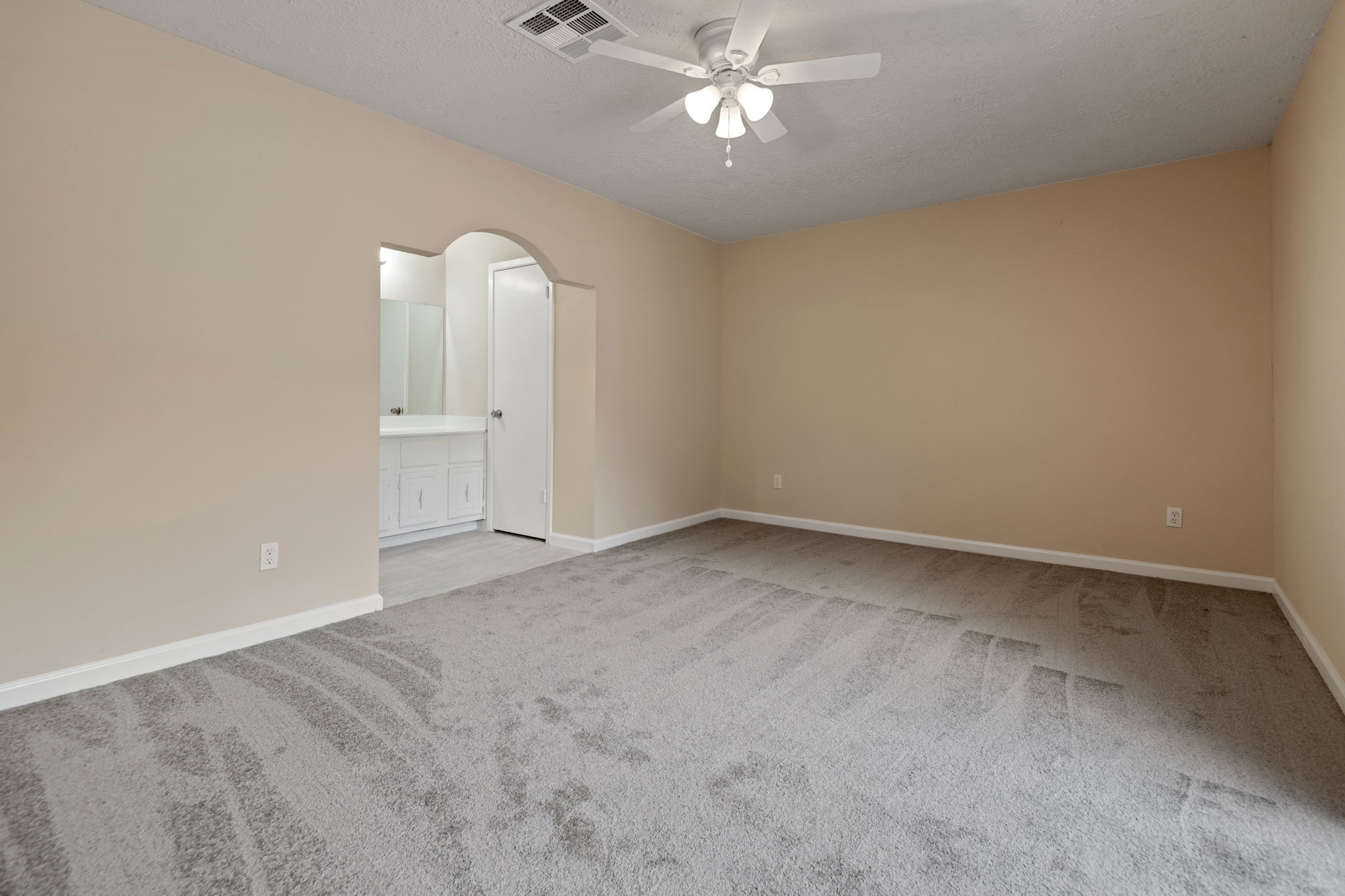 13315 Cologne Drive Houston, TX 77065 - Photo 10 of 15 an empty room with a chandelier fan and windows