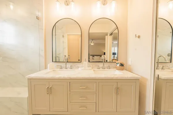 a bathroom with a double vanity sink mirror and