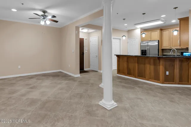 a view of a livingroom with workspace and a window