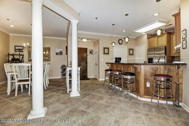 a view of a kitchen with dining area and chandelier