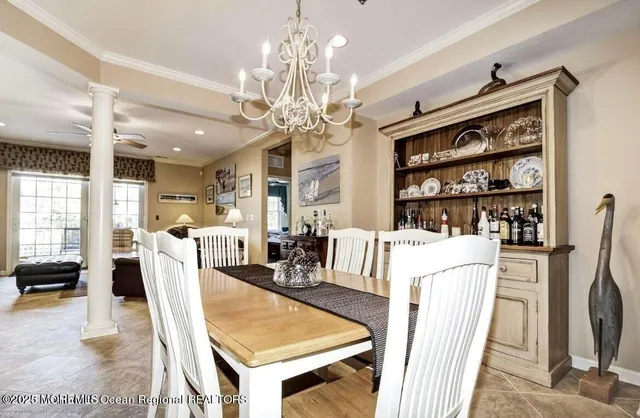 a living room with furniture a dining table and a chandelier