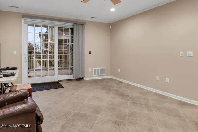 an empty room with a ceiling fan and a window