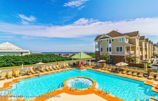 a view of swimming pool with outdoor seating