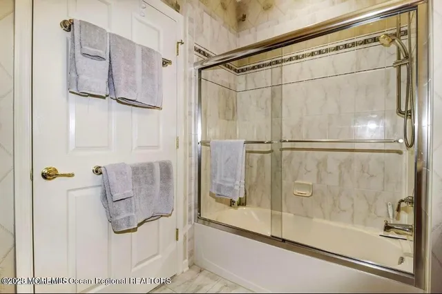 a bathroom with a granite countertop sink mirror vanity and toilet