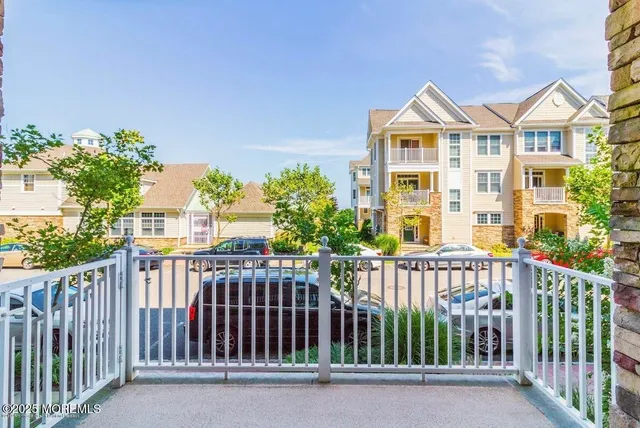 a view of a porch with wooden chairs