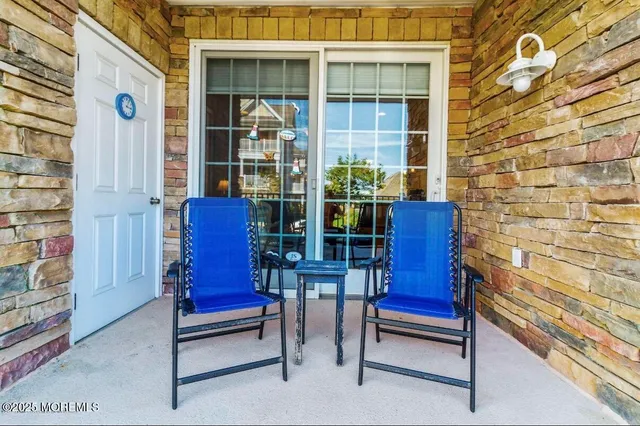 a view of a house with a small yard and wooden floor and fence