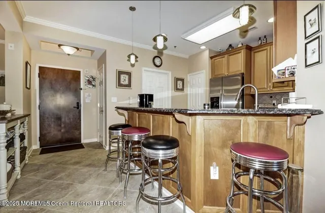 a kitchen with stainless steel appliances granite countertop a sink a stove and a refrigerator