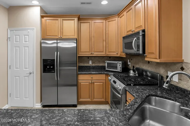 a bathroom with a sink a mirror and a shower