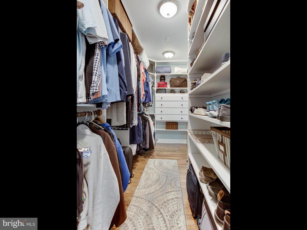 6678 Old Solomons Island Road Friendship, MD 20758 - Photo 32 of 57 a view of walk in closet with clothes and shoes