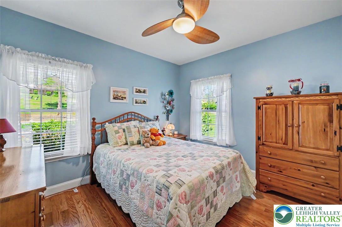 112 Michaels Run Road Stroudsburg, PA 18360 - Photo 27 of 69 Bedroom 2 has hardwood floors, 2 large windows, and a lighted fan.
