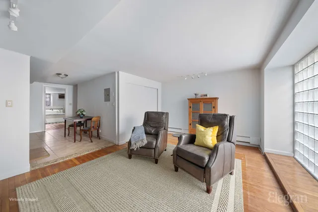 a kitchen with stainless steel appliances a stove a sink dishwasher and white cabinets with wooden floor