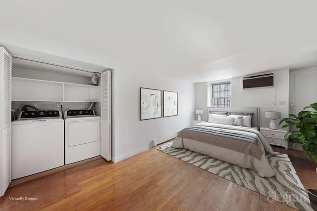 a spacious bedroom with a bed and cabinet