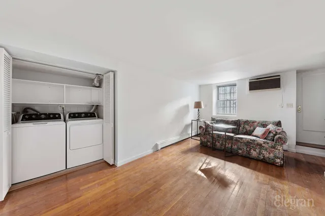 a spacious bedroom with a bed and a potted plant