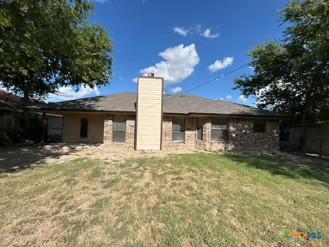 a front view of a house with a garden and patio