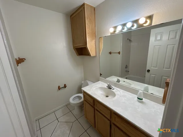 a bathroom with a sink a toilet and vanity