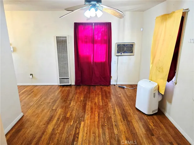 a view of a room with wooden floor and windows