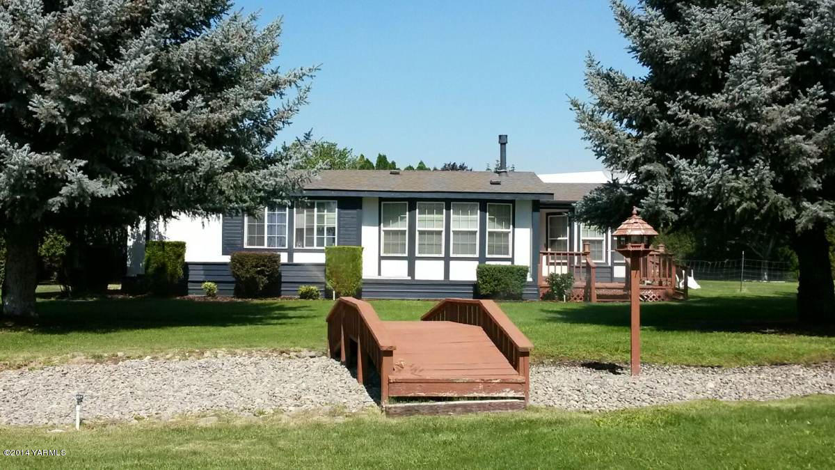 151 West Huntzinger Road Selah, WA 98942 - Photo 2 of 44 a view of a house with a yard porch and sitting area