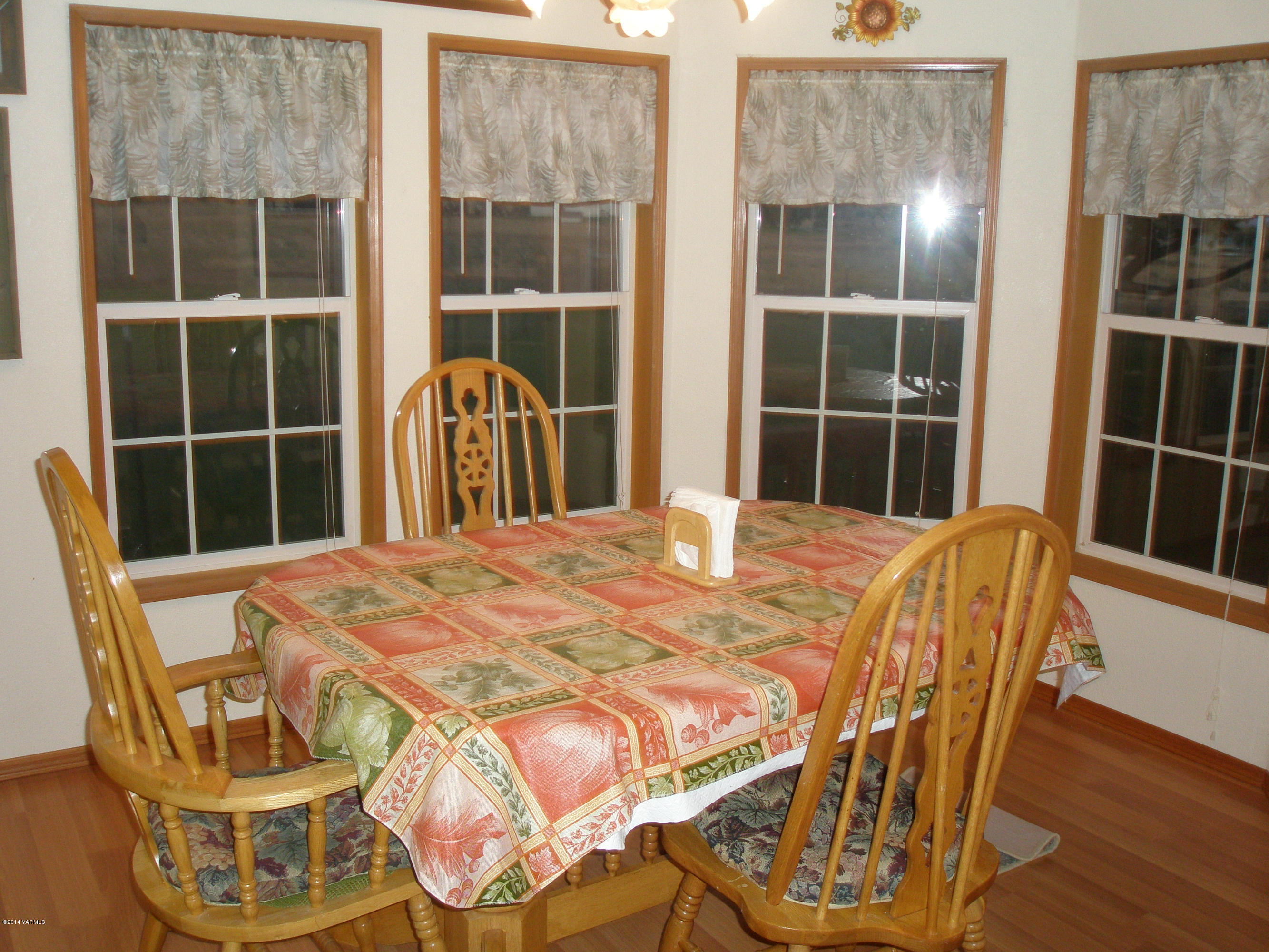 151 West Huntzinger Road Selah, WA 98942 - Photo 11 of 44 a view of a dining room with furniture and wooden floor