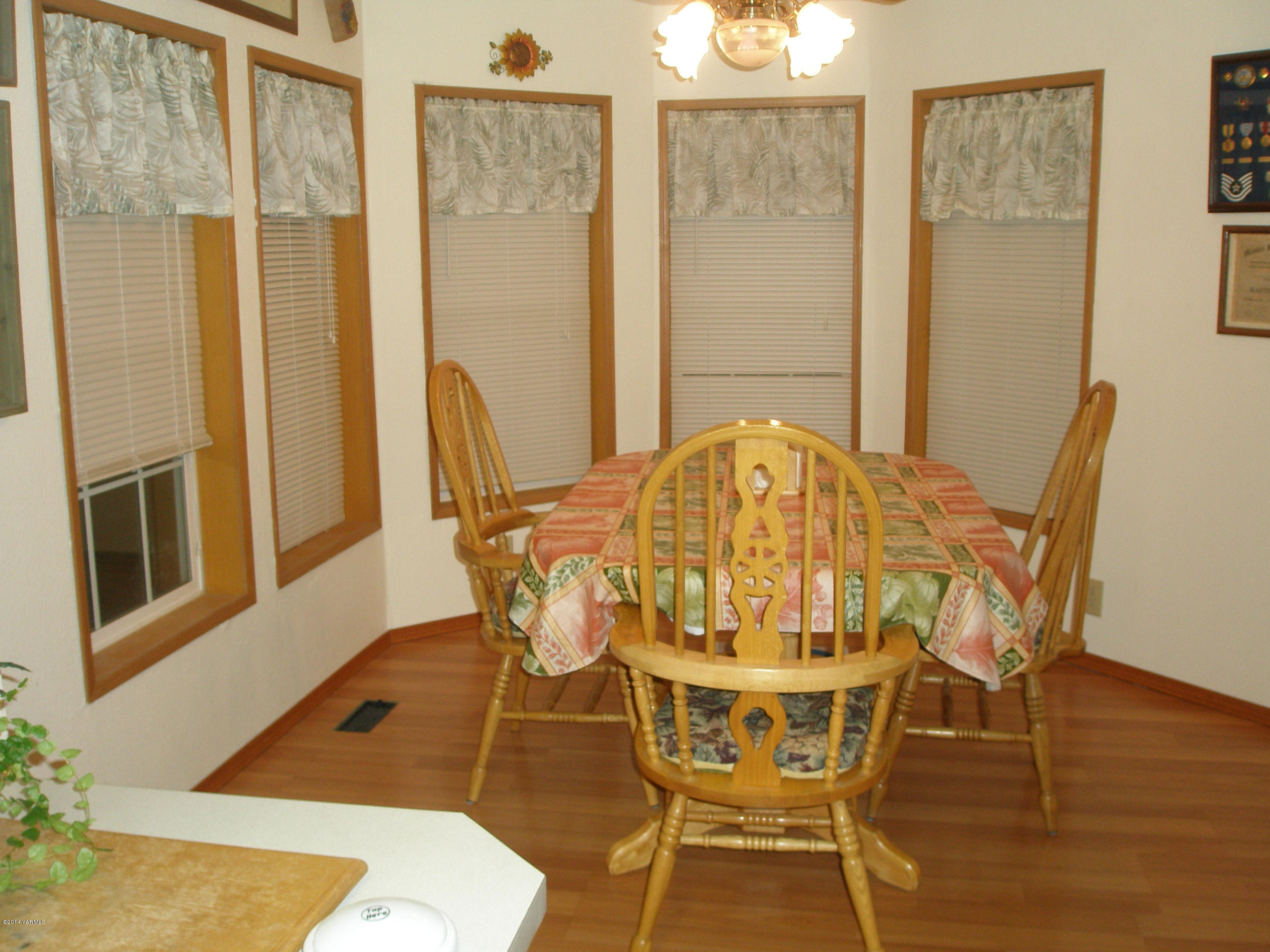 151 West Huntzinger Road Selah, WA 98942 - Photo 12 of 44 a view of a dining room with furniture and wooden floor