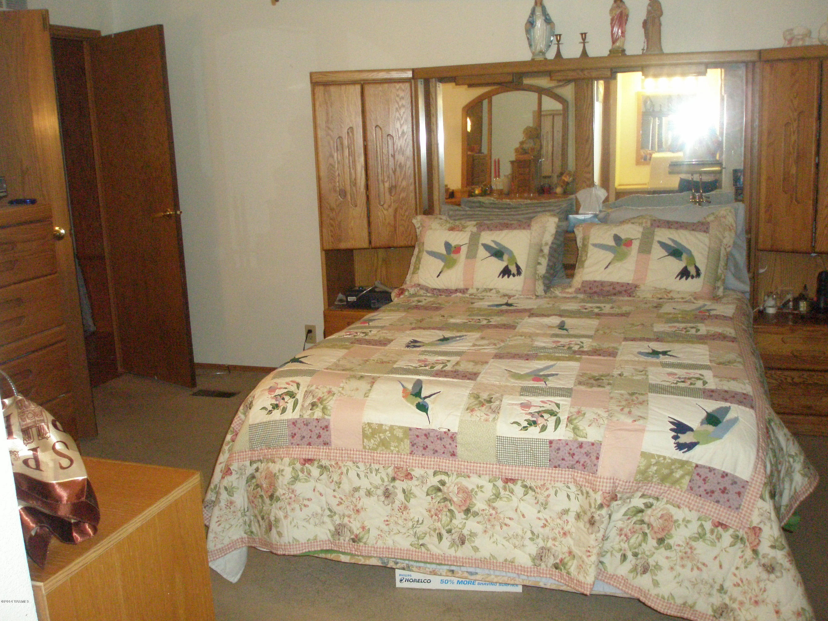 151 West Huntzinger Road Selah, WA 98942 - Photo 17 of 44 a bedroom with a bed and wooden floor