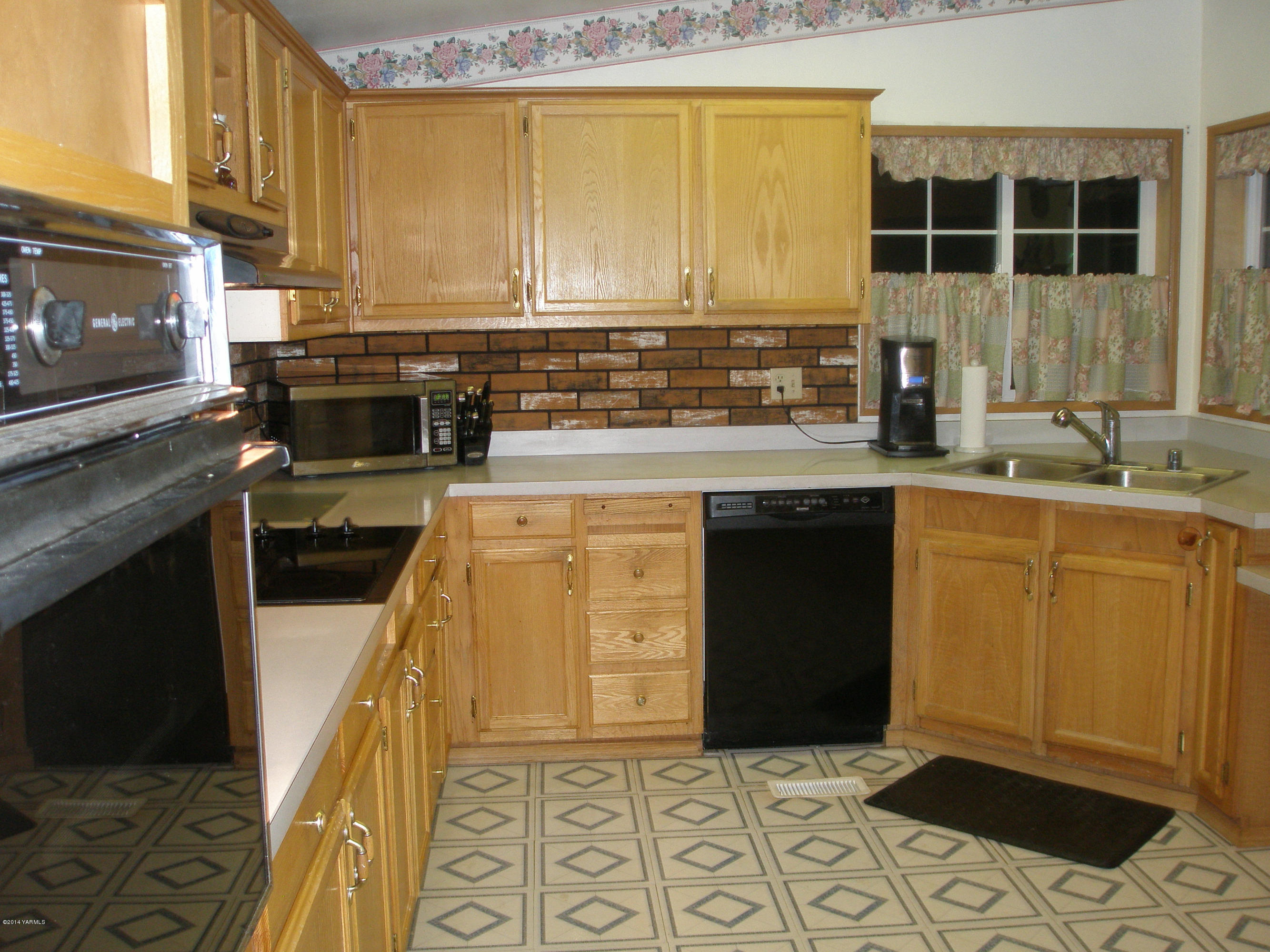 151 West Huntzinger Road Selah, WA 98942 - Photo 9 of 44 a kitchen with stainless steel appliances granite countertop a stove a sink and a microwave