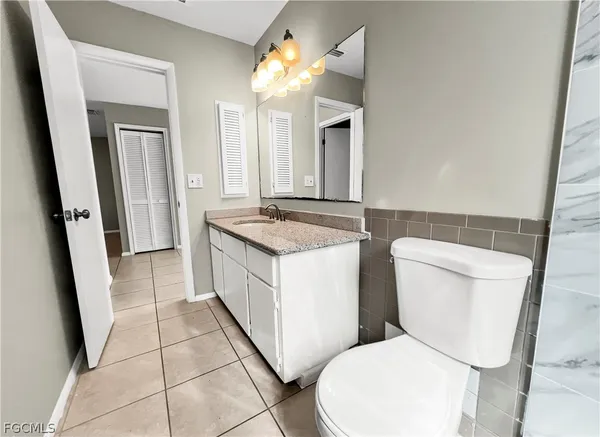 a white toilet sitting next to a bathroom sink