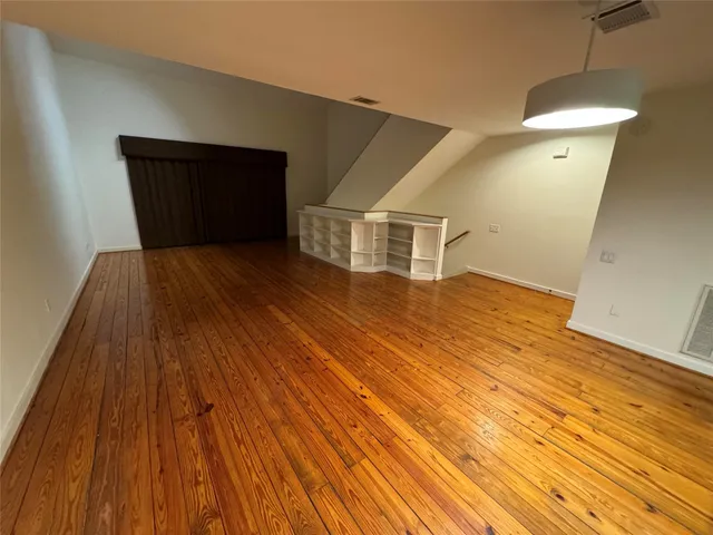 a kitchen with stainless steel appliances kitchen island granite countertop a refrigerator and cabinets