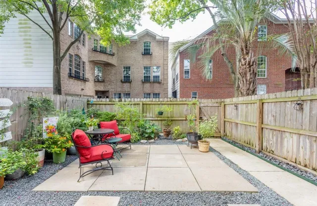 a kitchen with stainless steel appliances granite countertop a sink a stove and white cabinets