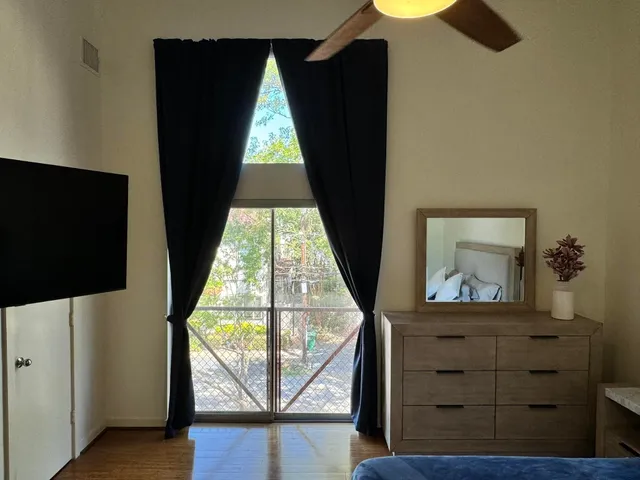 a bathroom with a sink a toilet a mirror and shower