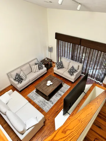 a view of a room with wooden floor and staircase
