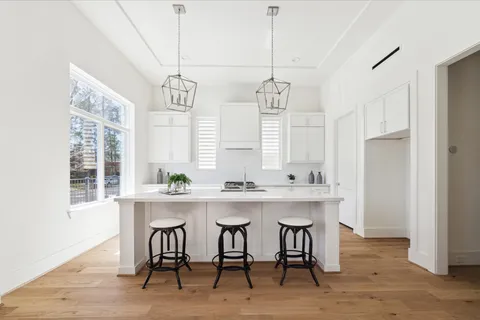 a kitchen with a table and chairs in it
