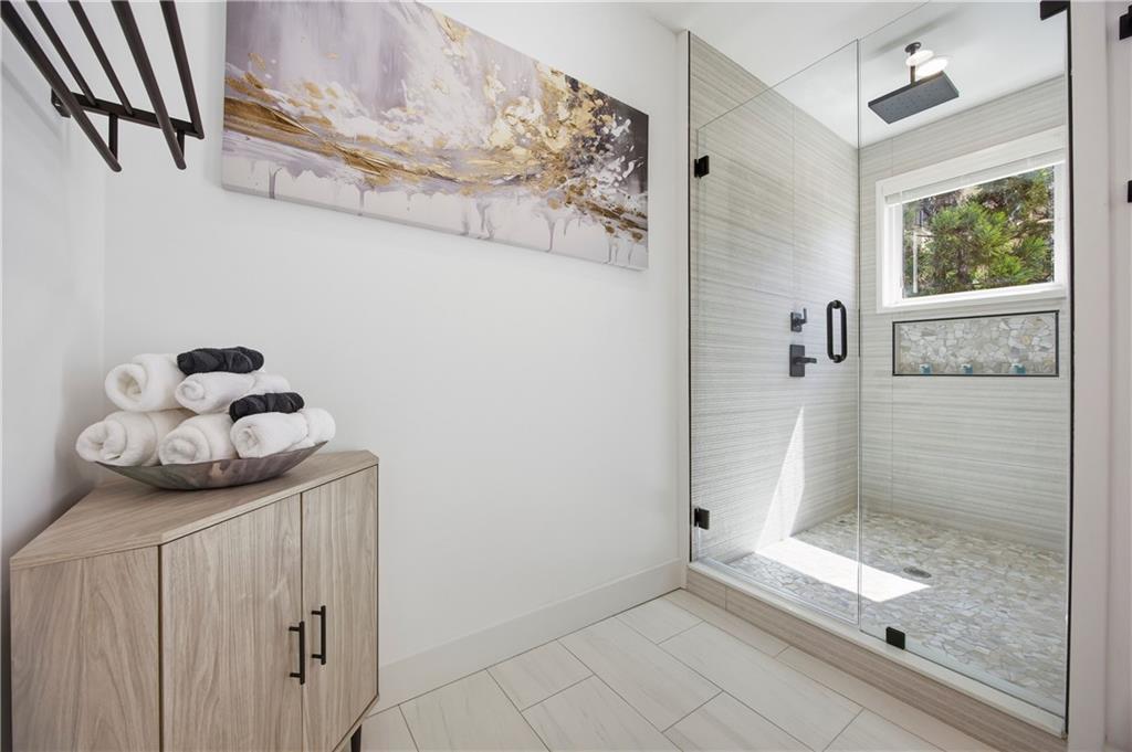 Undisclosed Address Atlanta, GA 30313 - Photo 21 of 38 a bathroom with a granite countertop sink a toilet and shower