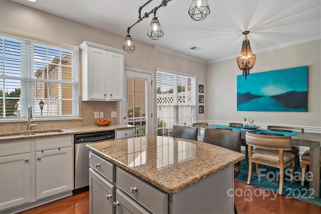 647 6th Baxter Crossing Fort Mill, SC 29708 - Photo 11 of 34 a kitchen with granite countertop a sink a counter space appliances and cabinets