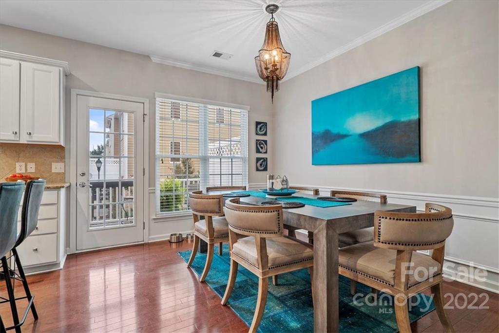 647 6th Baxter Crossing Fort Mill, SC 29708 - Photo 12 of 34 a view of a dining room with furniture wooden floor and chandelier