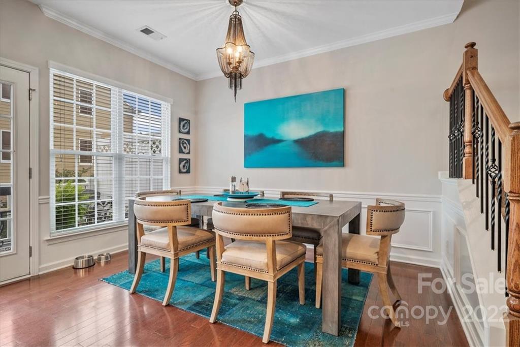 647 6th Baxter Crossing Fort Mill, SC 29708 - Photo 14 of 34 a view of a dining room with furniture wooden floor and chandelier