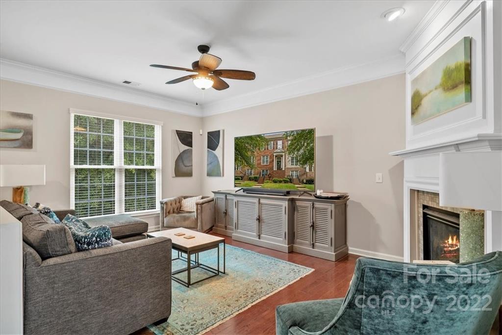 647 6th Baxter Crossing Fort Mill, SC 29708 - Photo 5 of 34 a living room with furniture a flat screen tv and a fireplace