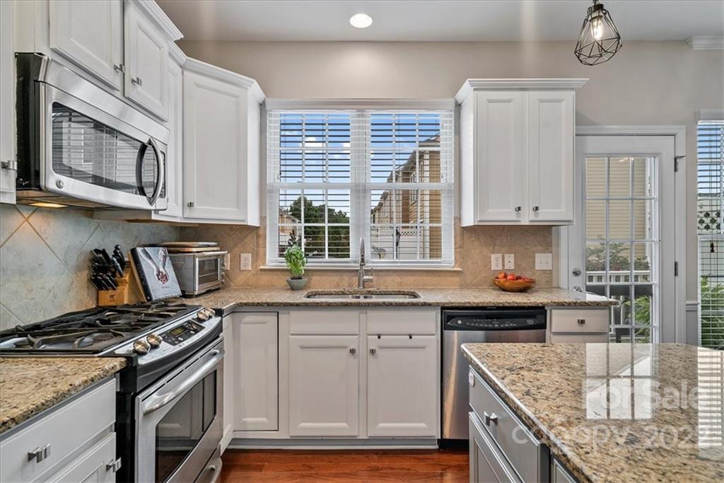 647 6th Baxter Crossing Fort Mill, SC 29708 - Photo 8 of 34 a kitchen with stainless steel appliances granite countertop a stove sink and cabinets