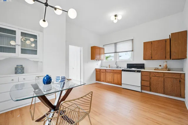 a kitchen with stainless steel appliances kitchen island granite countertop a sink cabinets and wooden floor