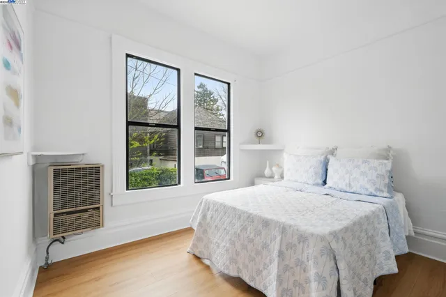 a bedroom with a large bed and a large window