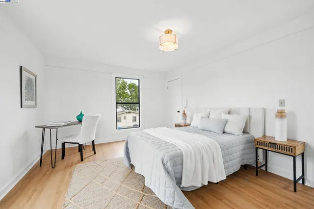 a bedroom with a bed lamps and a window