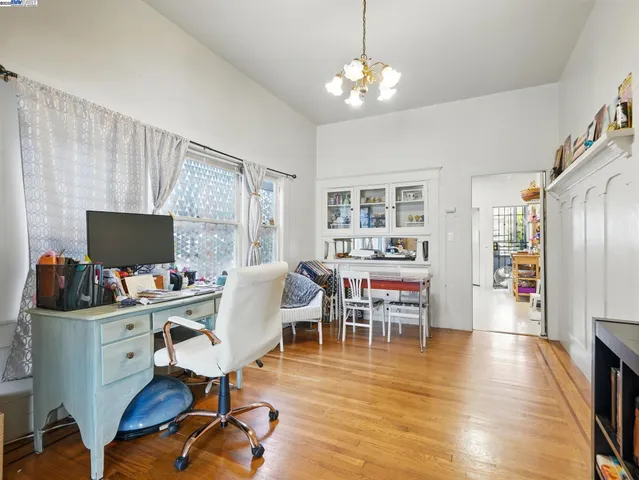 a view of a livingroom with workspace and a window