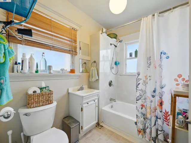 a bathroom with a sink a toilet and shower curtain